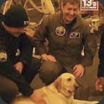 Sage with sailors in an IRL shipboard photo.